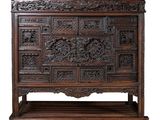 an old wooden chest with carved panels on top of it
