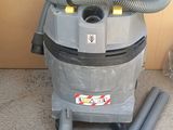a vacuum that is sitting on the floor next to some pipes