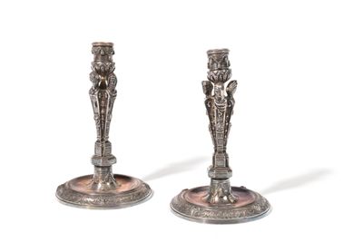 pair of antique silver candlesticks on stand on white background