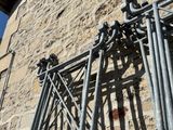 a metal gate on the side of a brick building
