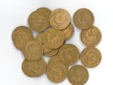 une pile de pièces d'or posée sur une surface blanche
