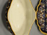 pair of blue and yellow porcelain bowls and a bowl on a table