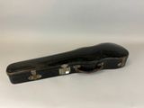 a black guitar case sitting on a white surface