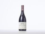 a bottle of red wine sitting on top of a table