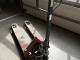 a hand truck that is sitting in front of a window