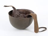 a brown bowl with a wooden spoon in it