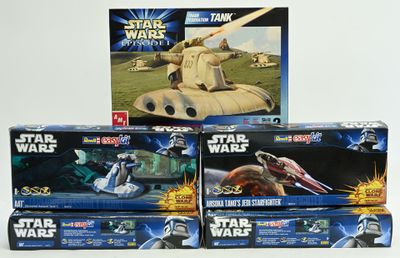 several star wars toys are stacked on top of each other