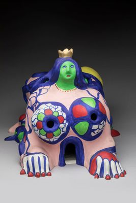 ceramic figurine of a woman with a crown on her head