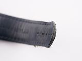 an image of a close up of a piece of black leather on a white surface