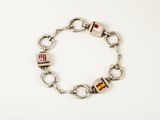 a close up of a bracelet on a white surface