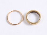 two gold wedding rings on a white surface