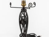 a black table lamp with a light bulb on top of it