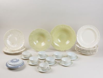 a lot of plates and bowls sitting on a table