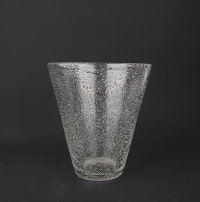 a close up of a clear glass cup on a black background