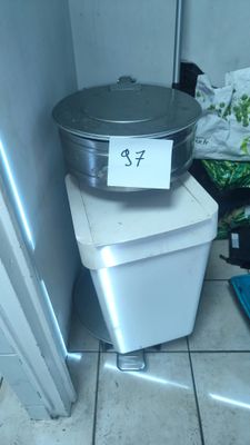 a trash can sitting on top of a trash can next to a trash can