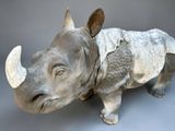 a sculpture of a rhino that is standing on a table
