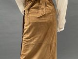 an image of a mannequin dressed in a white shirt and tan skirt