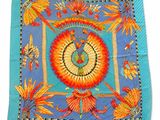 une image représentant une écharpe bleue et orange ornée d'un oiseau