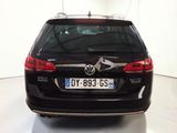 a black car that is parked in a white room