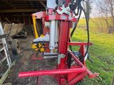 a red machine that is sitting in the grass
