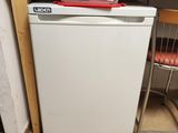 a small white dishwasher in a small kitchen