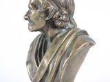 bronze bust of a man in a robe on a marble base