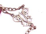 a close up of a necklace with a chain on it