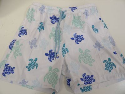a close up of a white shorts with blue turtles on it
