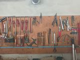 many tools hanging on the wall in the garage