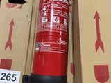 a red fire extinguisor sitting on a cardboard box