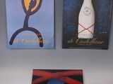 three posters on the wall of a wine shop