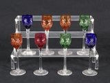 six wine glasses in a clear holder on a black background