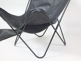 a black leather butterfly chair with a black leather bag