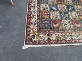 a rug on the floor with a chair in the background