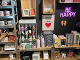 a woman that is standing in front of some shelves