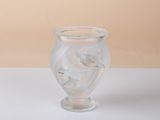 a clear glass vase sitting on a white surface