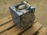 a fan sitting on top of a blue box on a wooden pallet