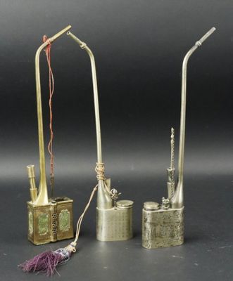 three different types of brass objects on a black surface
