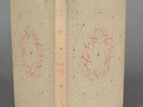 an old book with writing on it sitting on top of a table