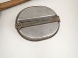a baseball bat sitting next to a metal object on a table