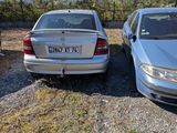 two cars parked in a parking lot with mountains in the background