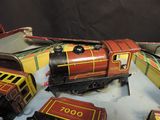 a toy train that is sitting on a table next to other toy trains