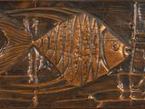 a fish carved into the side of a wooden box