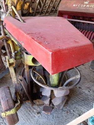 a red box sitting on top of a machine in a garage