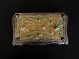 an image of a gold and green box with a bird on it