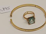une image représentant une bague en or sertie d'une pierre verte