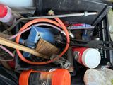 a bucket full of tools and a brush in it