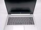 a laptop that is open on a white table