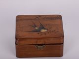 a small wooden box with a bird on it