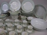 many different types of plates and bowls on the table